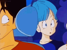 a man and a woman are sitting next to each other in a car . the woman is wearing a blue headrest .