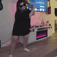 a woman playing a guitar in front of a tv screen that says ' i 'm a bitch ' on it