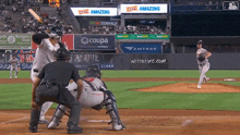 a baseball game is being played in a stadium sponsored by coupe