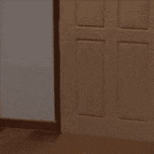 a stuffed animal with a face drawn on it is standing next to a door .