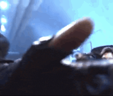 a blurred image of a person 's finger pointing up