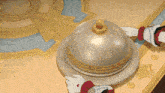 a cartoon illustration of a bell with a gold top