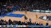 a basketball game is being played in front of a large crowd