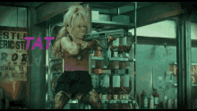 a girl holding a gun in front of a sign that says revenge to august 9th