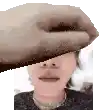 a hand is covering a woman 's face in a pixel art image .