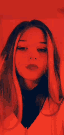 a close up of a woman 's face in a red light