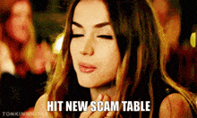 a woman with her eyes closed and the words hit new scam table