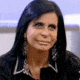 a woman with long black hair is making a funny face .