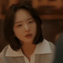 a close up of a woman 's face with a serious look on her face