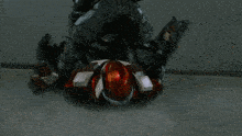 a red and white object is against a concrete wall
