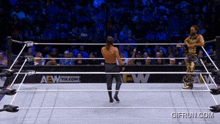 two wrestlers in a wrestling ring with a aew logo on the side