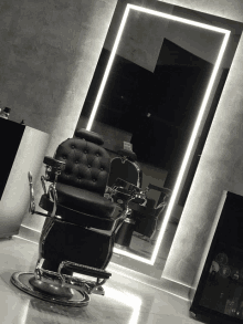 a barber chair in front of a mirror with a sign that says ' barber shop ' on it