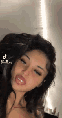 a woman 's face is shown in a tiktok video with a t on the bottom