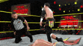 a wrestler is kneeling down in front of a sign that says tna impact