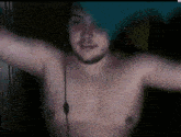 a shirtless man with a beard is standing in the dark with his arms outstretched