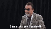 a man wearing sunglasses and a plaid suit says " sa man skal selv fremtidise "