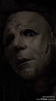 a close up of a man 's face with a mask on .