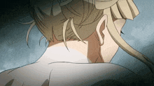 a close up of a woman 's neck and back in a bun .