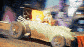 a cartoon character is driving a car with spongebob on the back seat