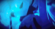 a person is standing in a dark room with blue lights behind them