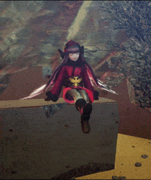 a girl in a red dress is sitting on a concrete block