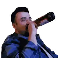 a man in a blue shirt drinks from a bottle