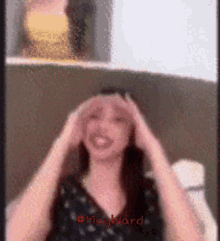 a blurred image of a woman with the word mayward on the bottom right