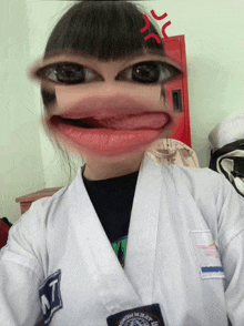 a girl wearing a white karate uniform with a patch that says taekwondo on it