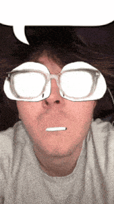 a man wearing glasses has a speech bubble above his eyes