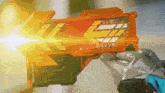 a person is holding a toy gun with the letter l on the front