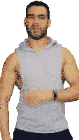 a man with a beard is wearing a sleeveless hoodie