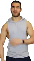 a man with a beard is wearing a sleeveless hoodie