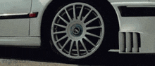 a close up of a wheel on a car with the word mg on the bottom right
