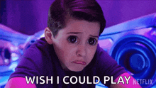a young boy is making a sad face and saying `` wish i could play '' .