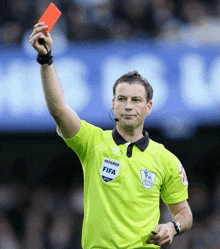 a referee wearing a green shirt that says referee fifa on it