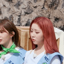 a girl with red hair wears a sash that says ' eee ' on it