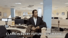 a man in a suit and tie is standing in an office with the words `` clark in every future otter time '' above him .