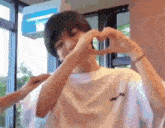 a man making a heart shape with his hands