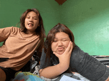 two girls are posing for a picture with one wearing a t-shirt that says ' sydney ' on it