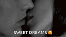 a black and white photo of a man and woman kissing with the words `` sweet dreams '' written below them .