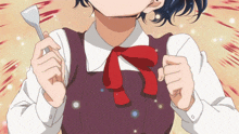 a girl with a red bow on her neck is holding a spoon
