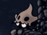 a cartoon character with a skull on its head is standing next to a tower in a dark room .