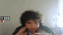 a blurry picture of a man with the number 1223 on the bottom