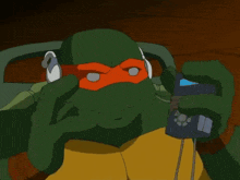 a teenage mutant ninja turtle wearing headphones and a red mask
