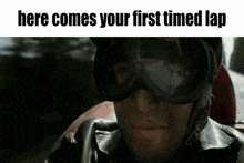 a man wearing goggles with the words here comes your first timed lap