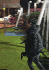 a blurry picture of a person standing on a green field