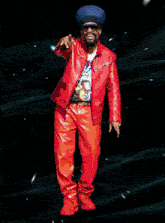 a man wearing a blue jacket and blue pants is dancing