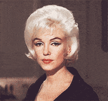 a woman with blonde hair and red lips is wearing a black top