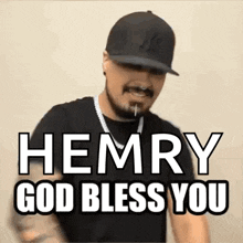 a man with a beard and mustache is wearing a hat and necklace and says `` hemry god bless you '' .