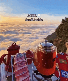 a picture of saudi arabia with a teapot and cups in the foreground